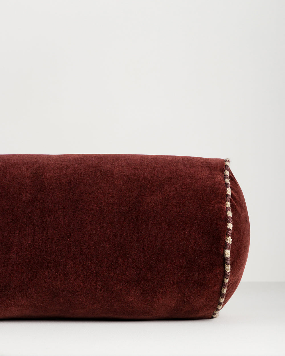ELLIOT VELVET BOLSTER CUSHION - OXBLOOD
