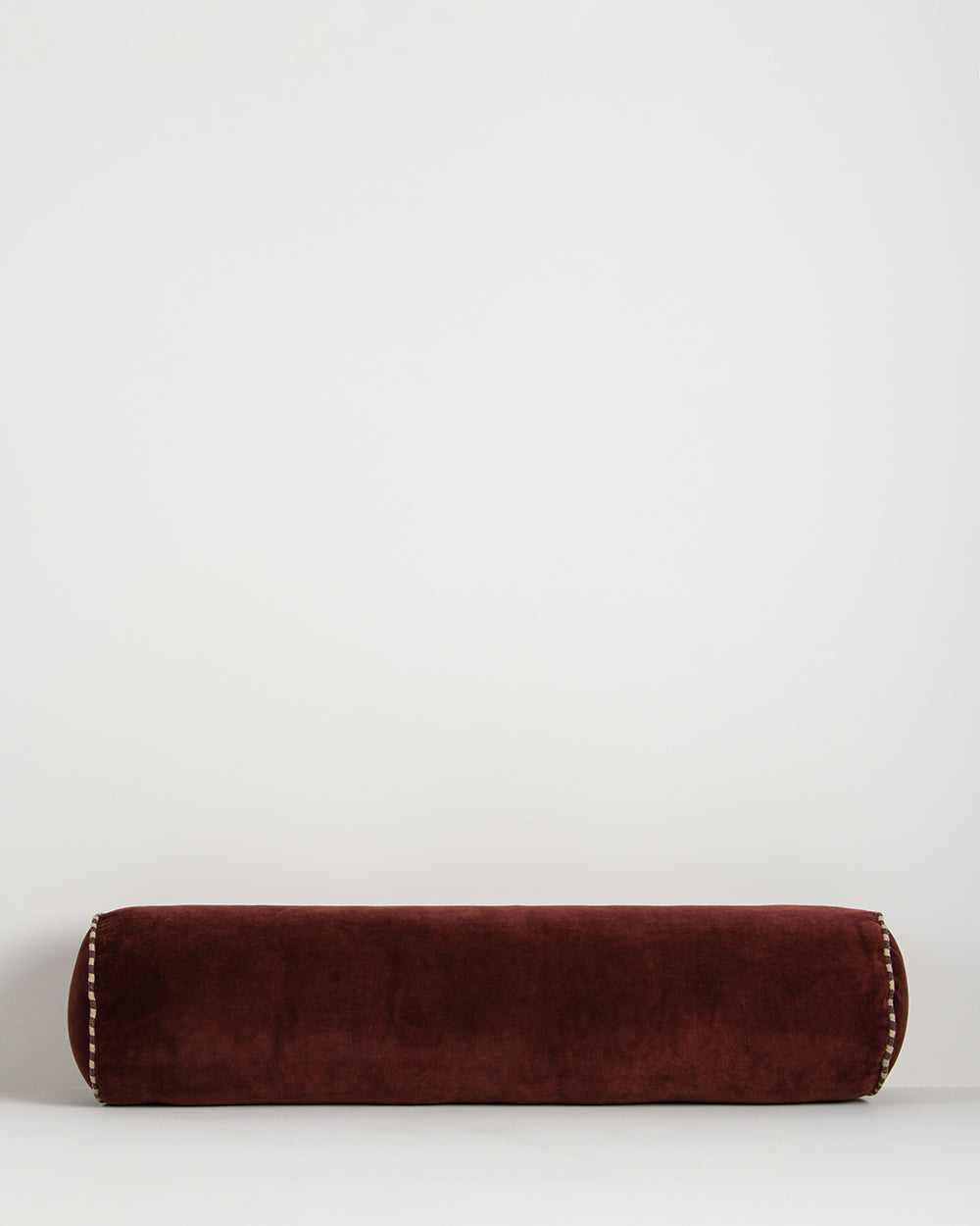ELLIOT VELVET BOLSTER CUSHION - OXBLOOD